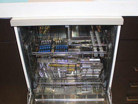 The inside of a Miele washer with cassettes used for sanitation