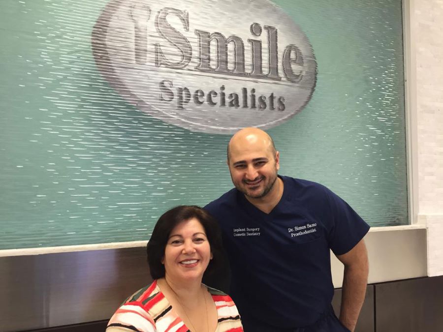 Dr. Samo with a Happy patient after getting 5 implants, " permission to publish on file"