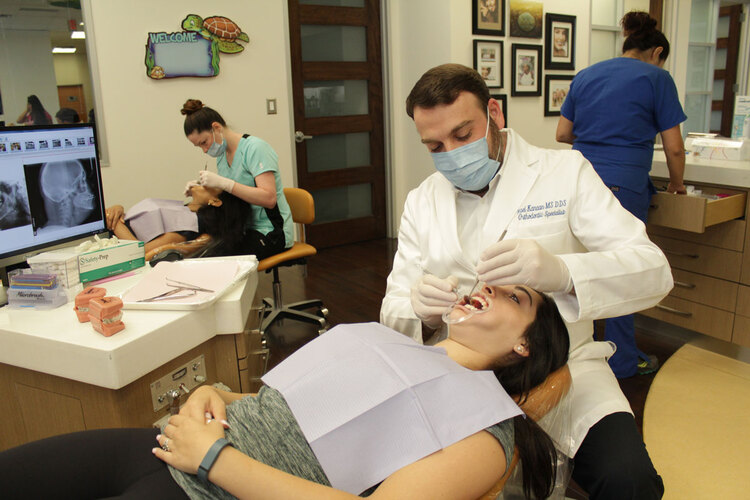 Orthodontist Dr. Kanaan working on a patient in the ortho bay. 