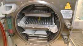 Autoclave open and loaded with cassettes ready to steralize dental instruments